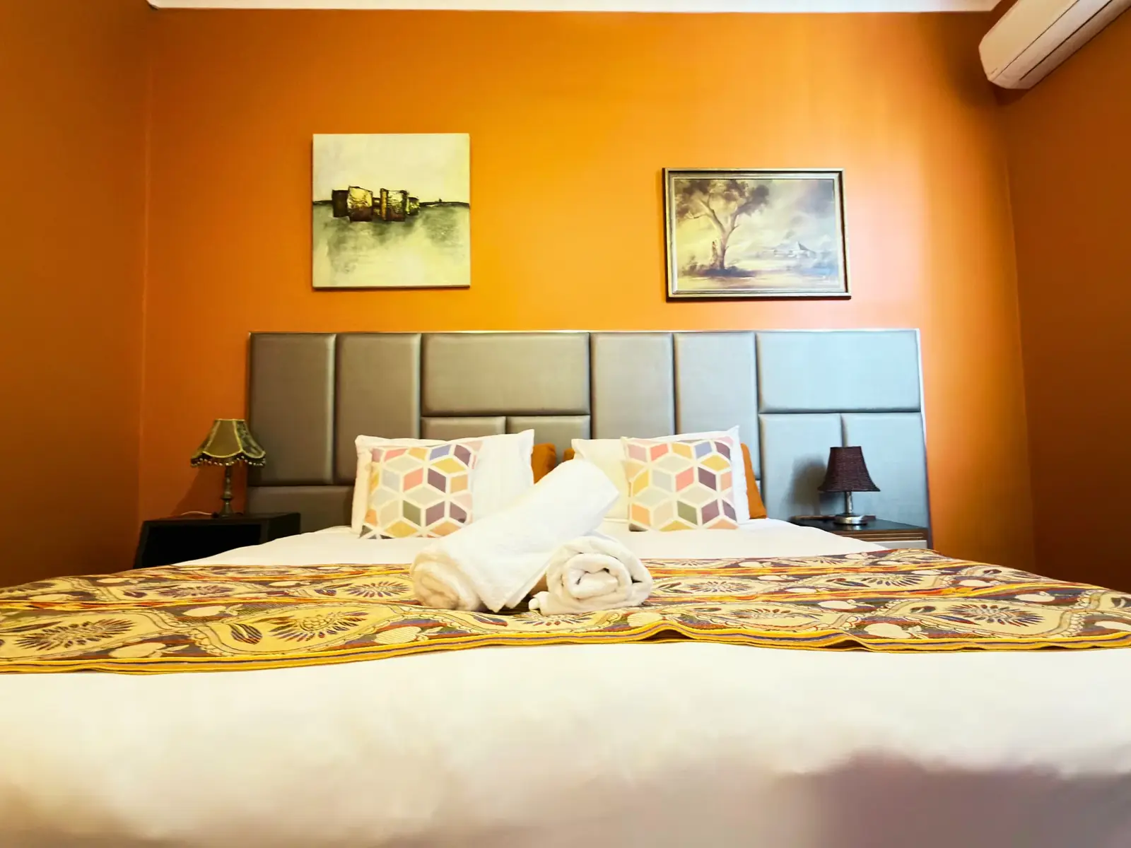 King bed with upholstered headboard — King Room at Vine Valley Inn Cessnock
