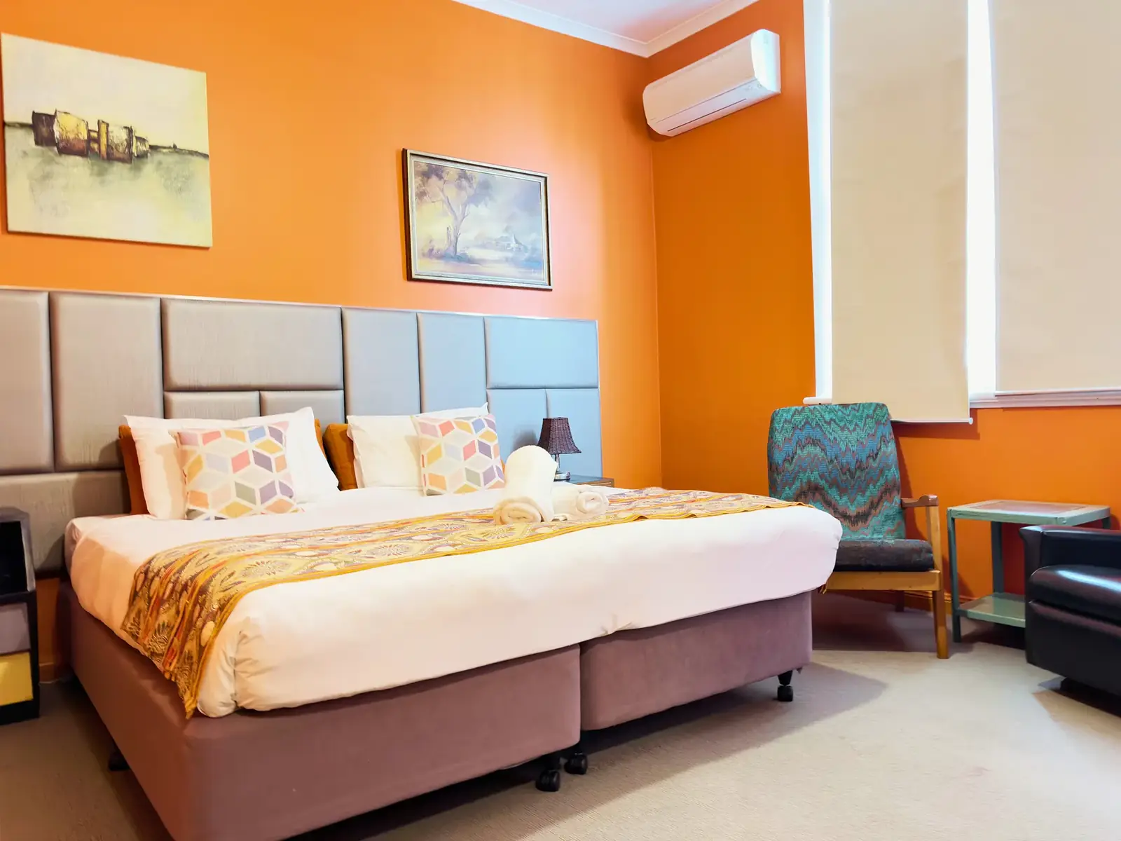 King bed with armchair — King Room at Vine Valley Inn Cessnock
