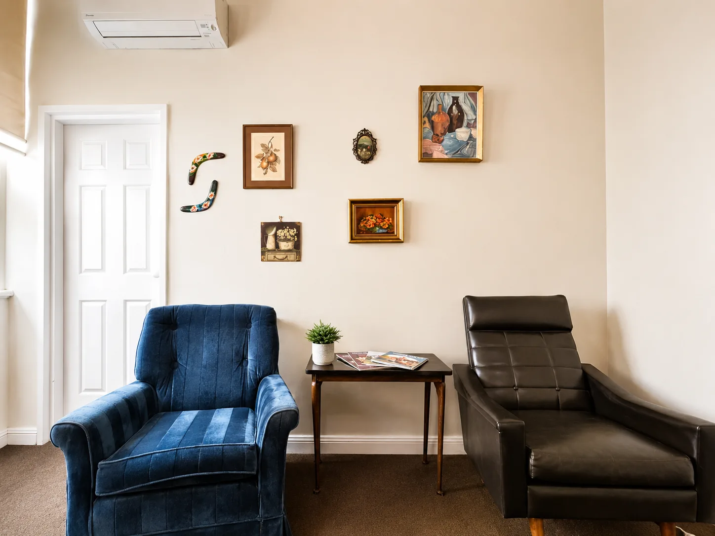 Guest seating with gallery wall — King Room at Vine Valley Inn Cessnock