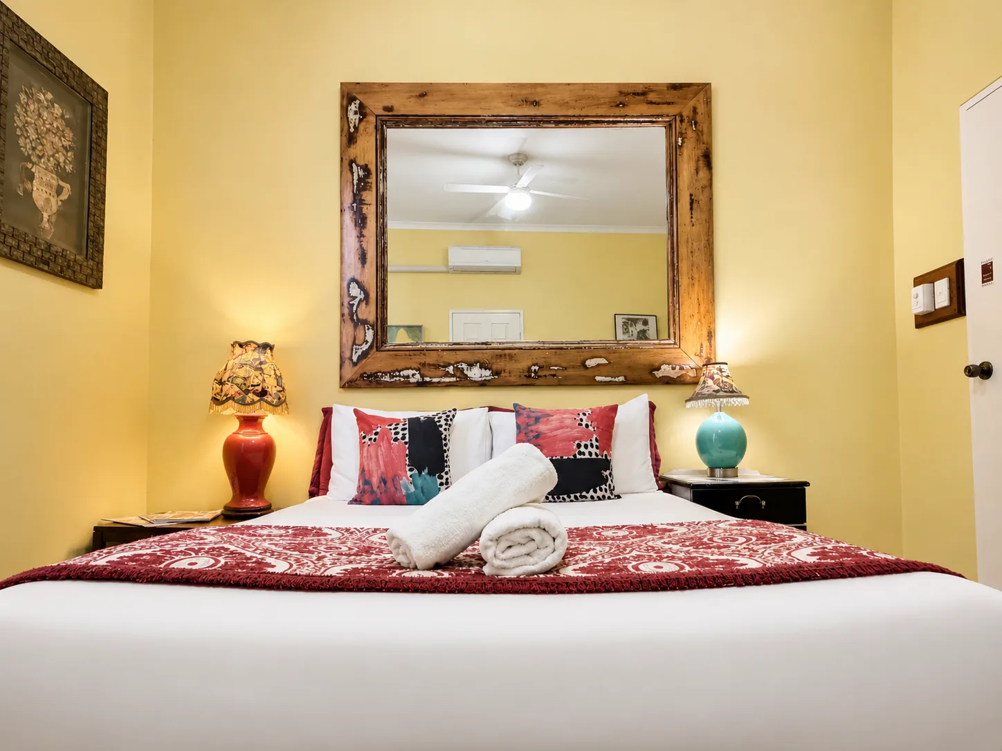 Queen bed with vintage mirror — Queen Deluxe Room at Vine Valley Inn Cessnock